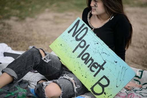 An activist sits during a youth climate rally on the west front of the US Capitol on March 15, 2019 in Washington, DC. (Photo by Brendan Smialowski / AFP) (Photo credit should read )