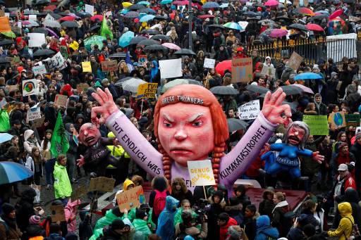 Students use a carnival float depicting Swedish environmental campaigner Greta Thunberg during a strike from school to demand action on climate change at the town hall square of Duesseldorf, Germany, March 15, 2019.