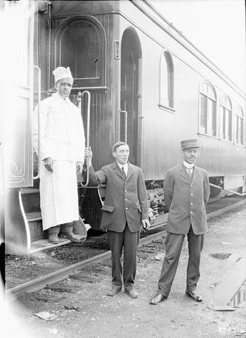Special train for Sir A. Conan Doyle to Mount Robson – Grand Trunk Pacific Railway – Chef and porters standing beside the train.
